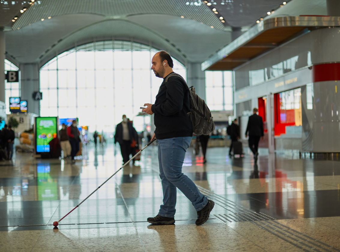 visually impaired passenger walking at the airport