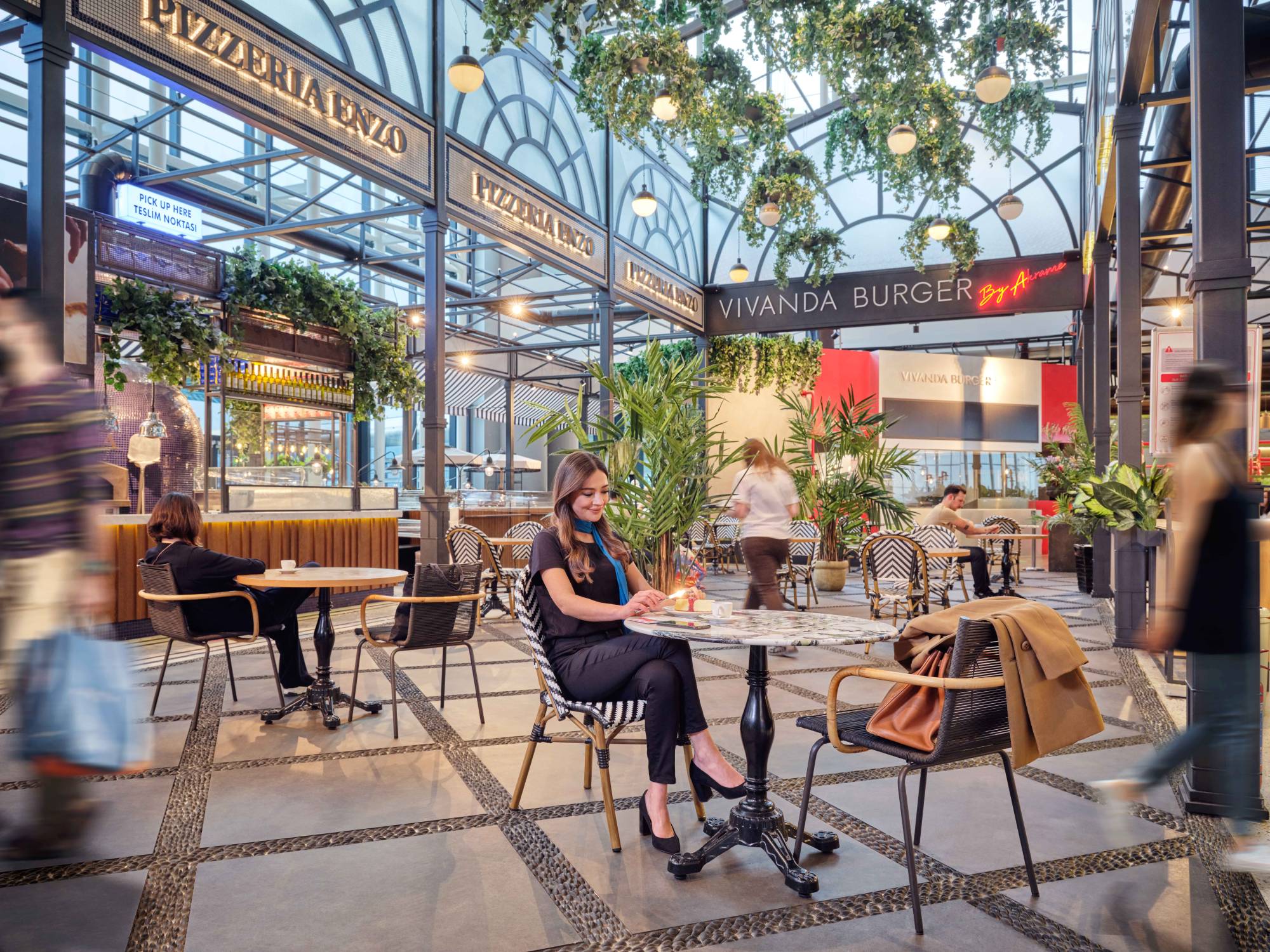 passengers sitting in the airport pizza restaurant