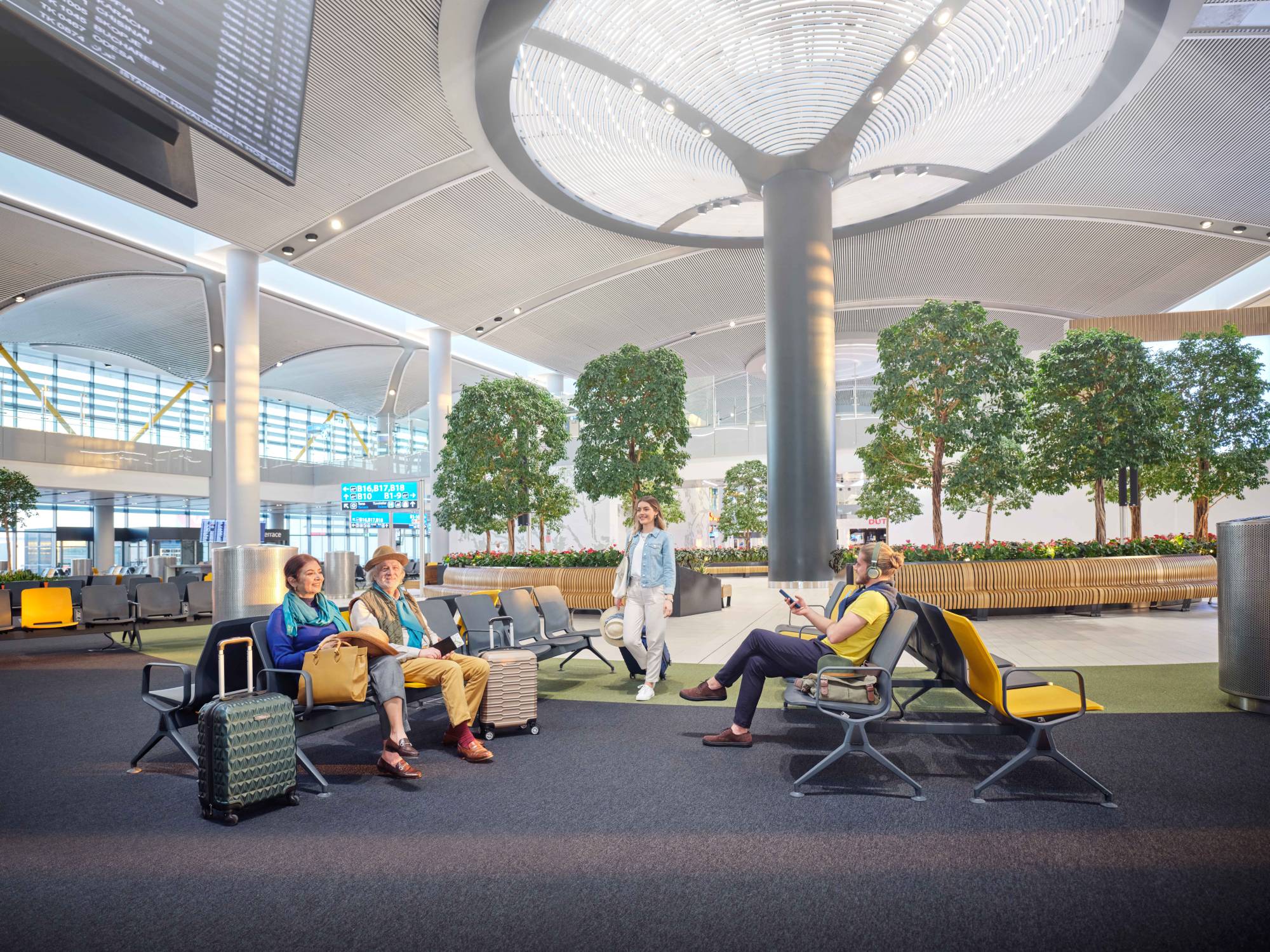 passengers sitting in the field of flight waiting